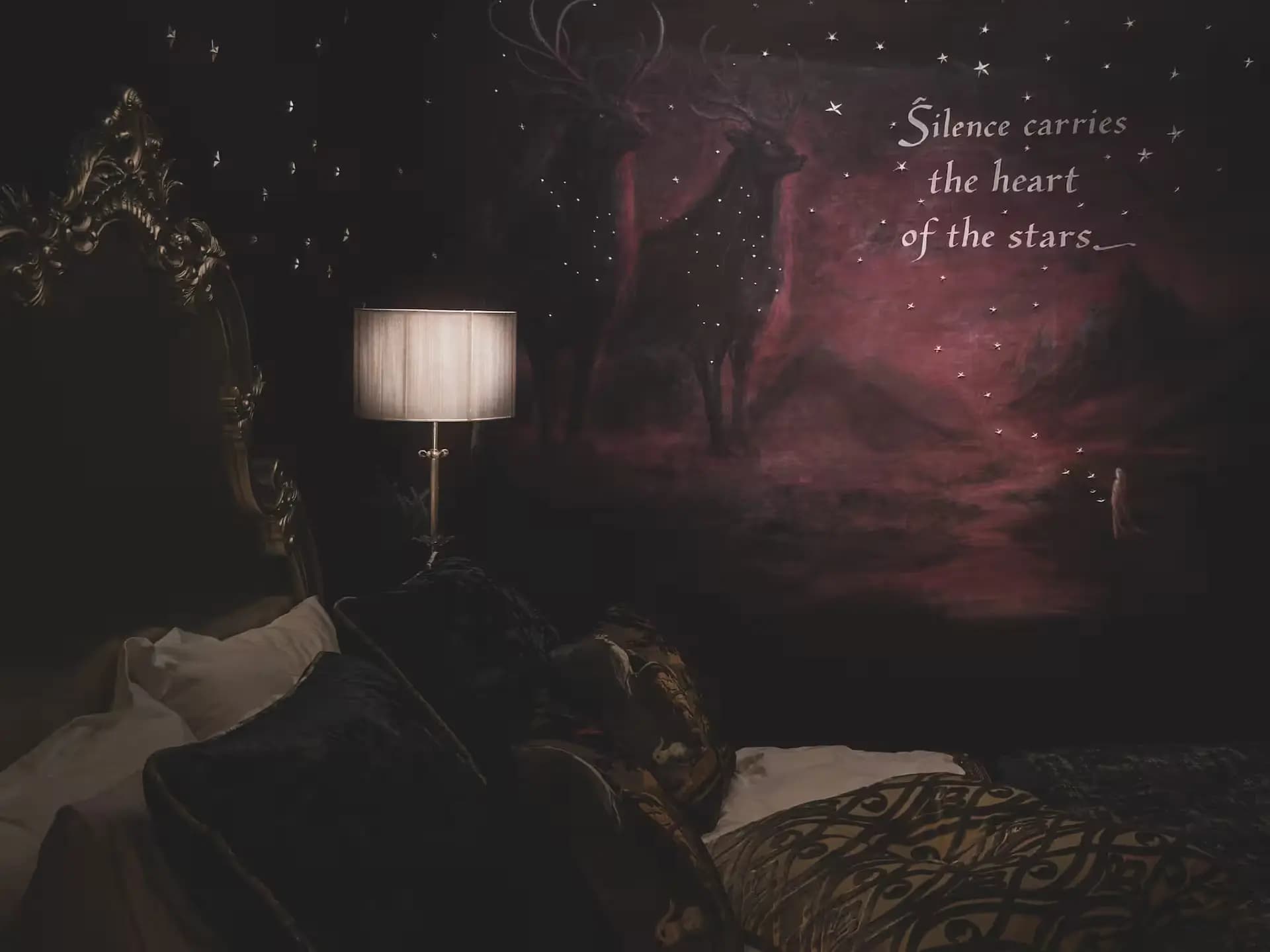 Dark bedroom with a painted stag mural inside Luxurious Home.