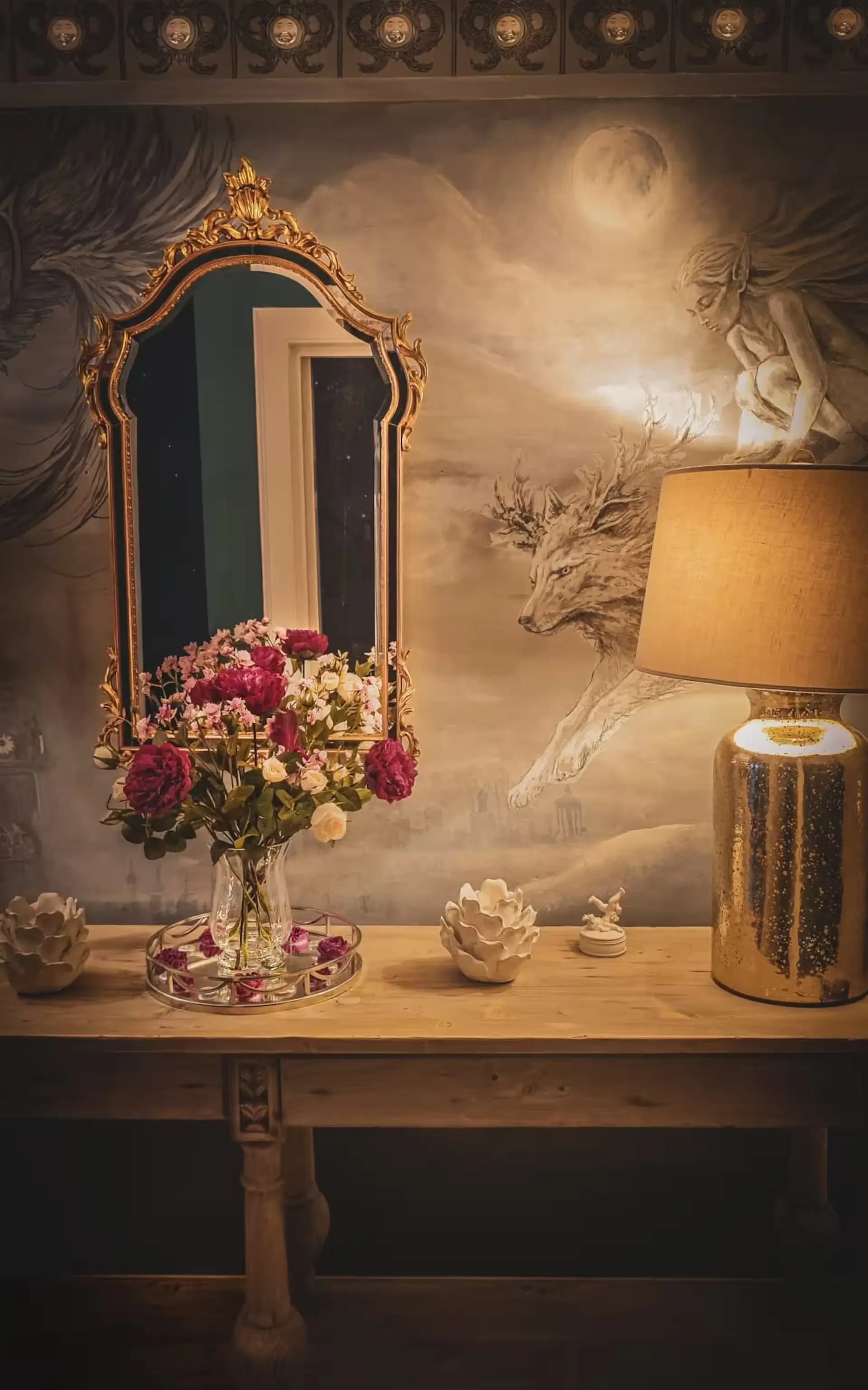 Console table, gold mirror and mural detail inside Luxurious Home.