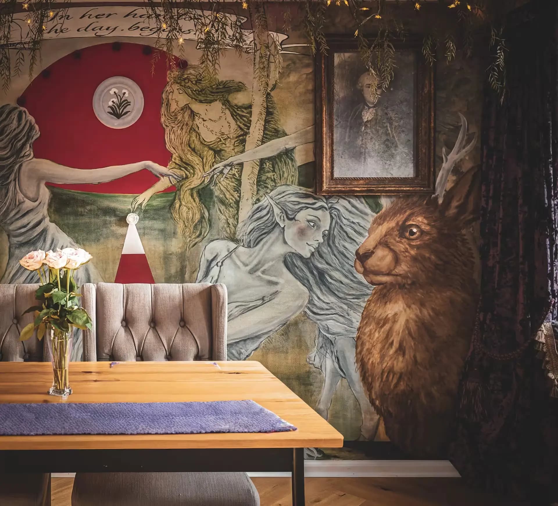 Dining table beside the mural wall inside Luxurious Home.