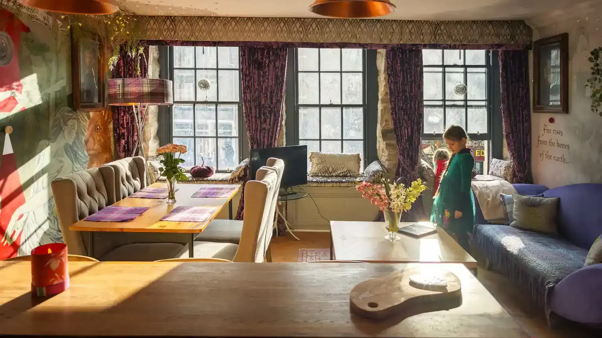 Living and dining area with three Grassmarket windows inside Luxurious Home.