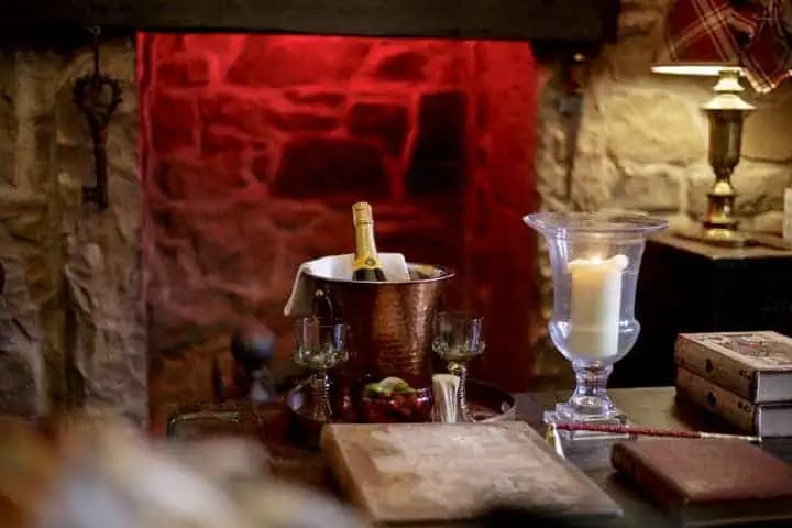 Candlelit fireplace detail inside The Outlander Lodge.