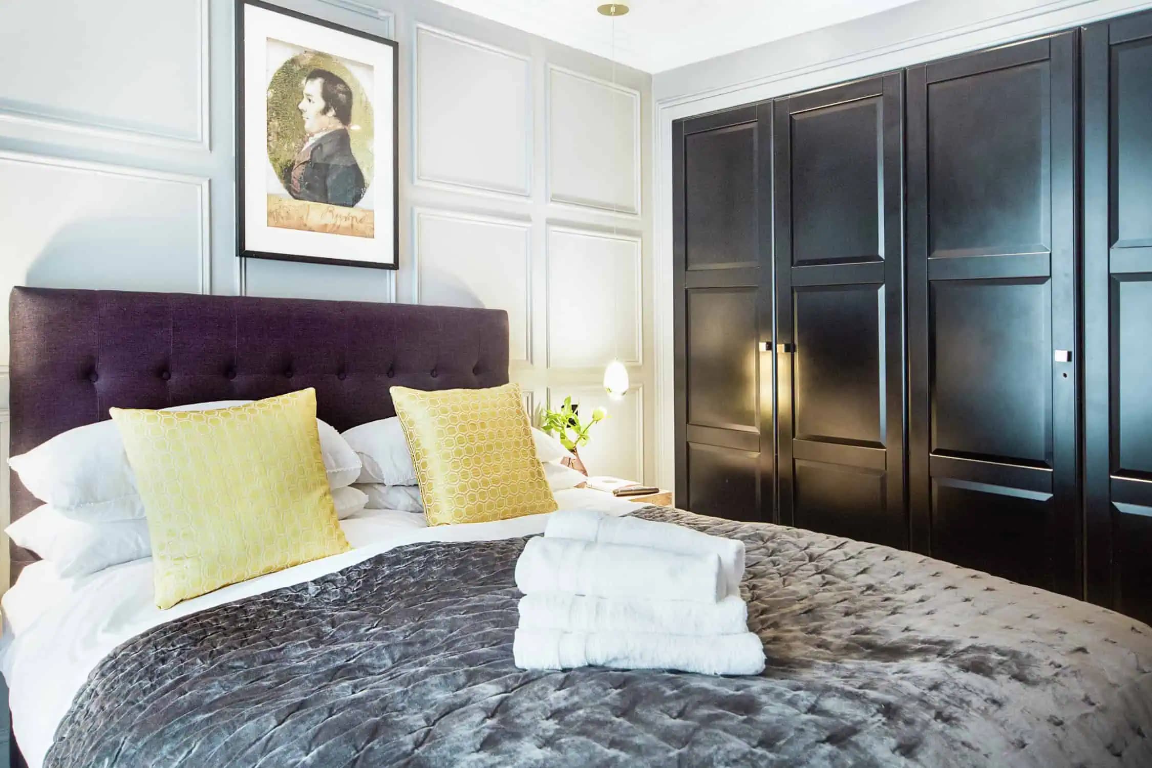 Wood-panelled bedroom with king size bed inside Romantic Stay.